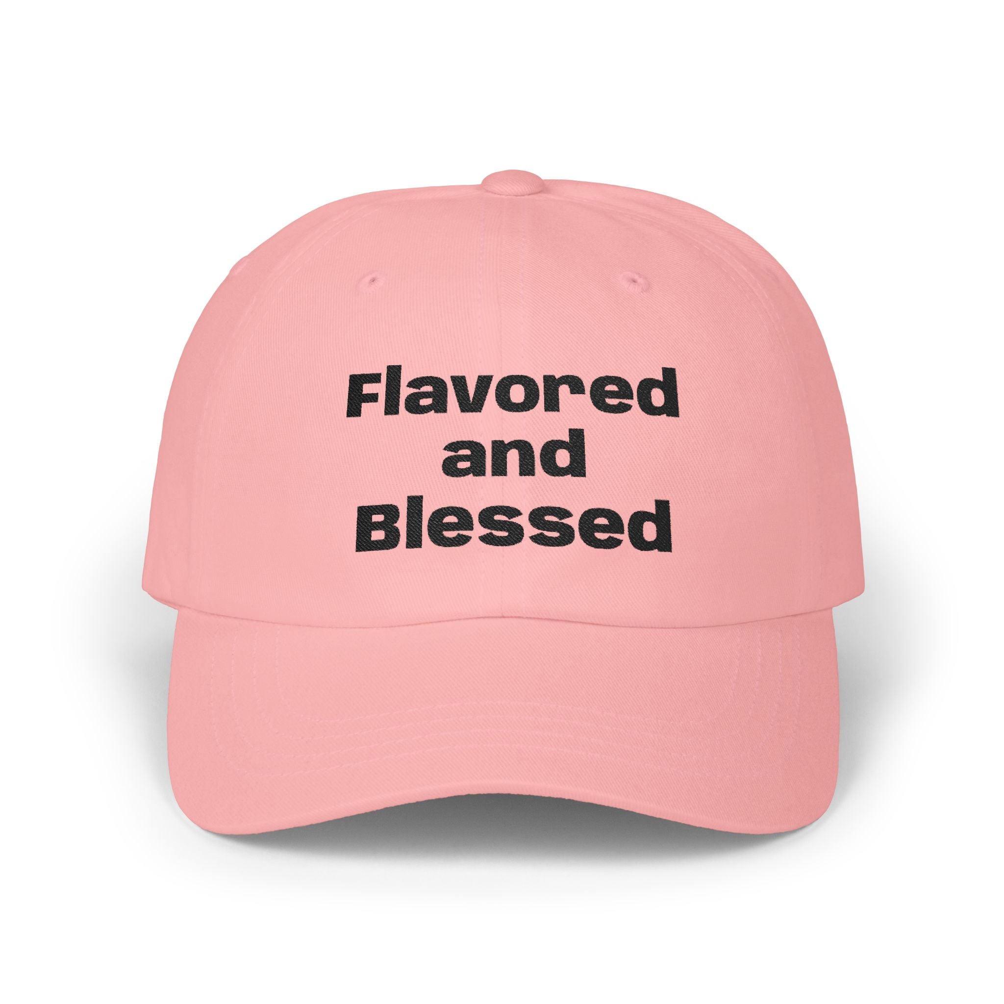 Pink cap with 'Flavored and Blessed' text on a white background
