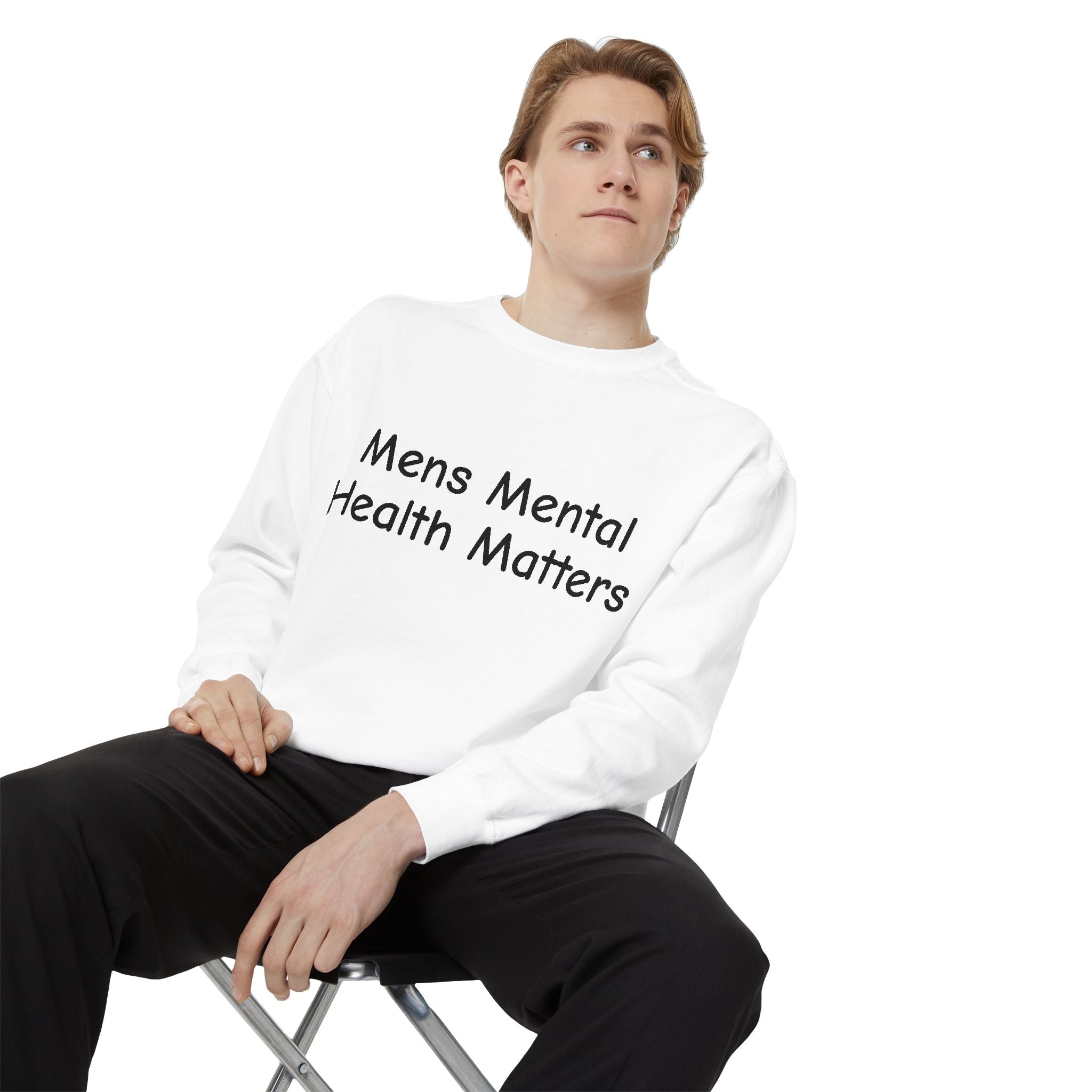 Person wearing a white sweatshirt with 'Mens Mental Health Matters' text, sitting on a chair against a white background.