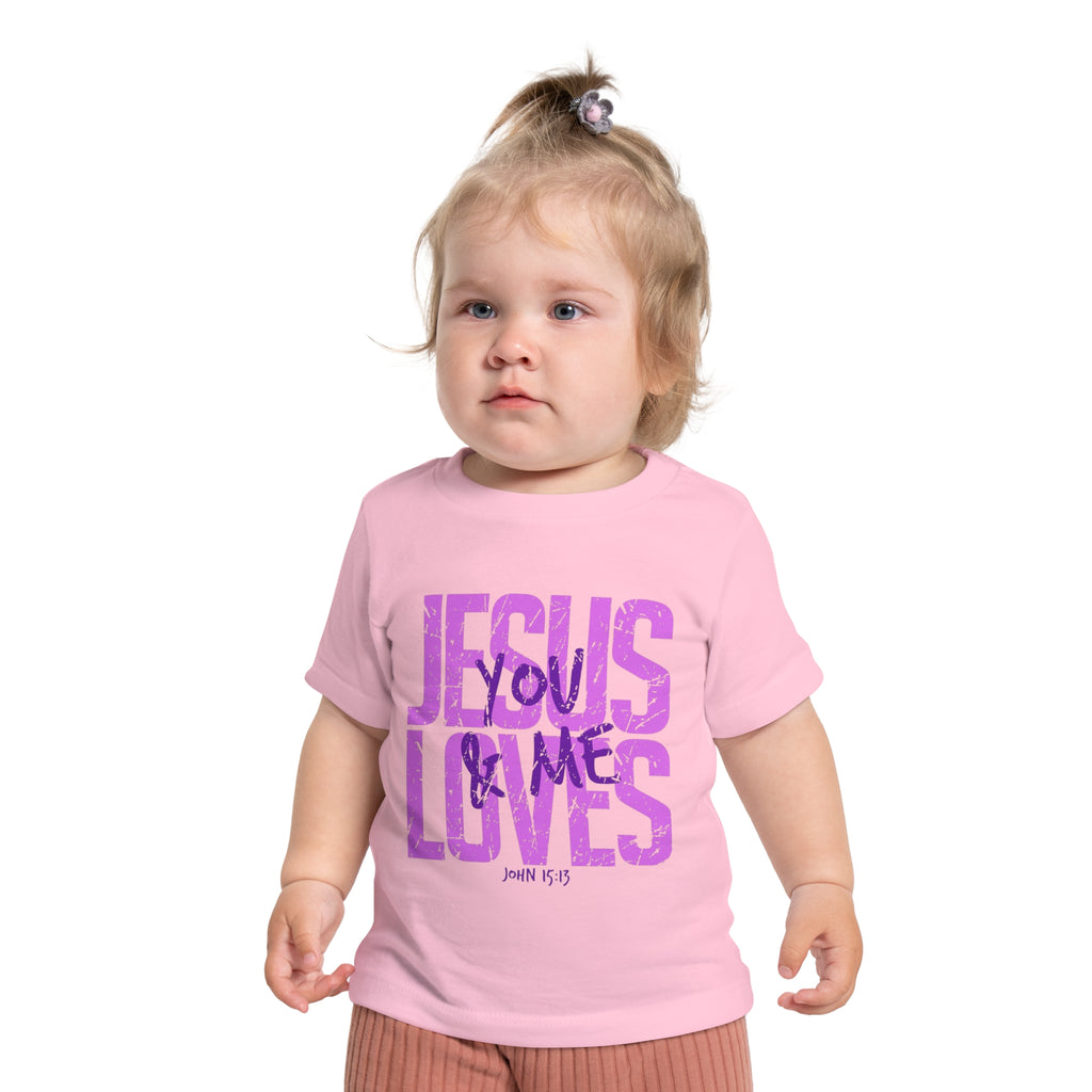 Child wearing a pink t-shirt with 'Jesus Loves You & Me' text on a white background